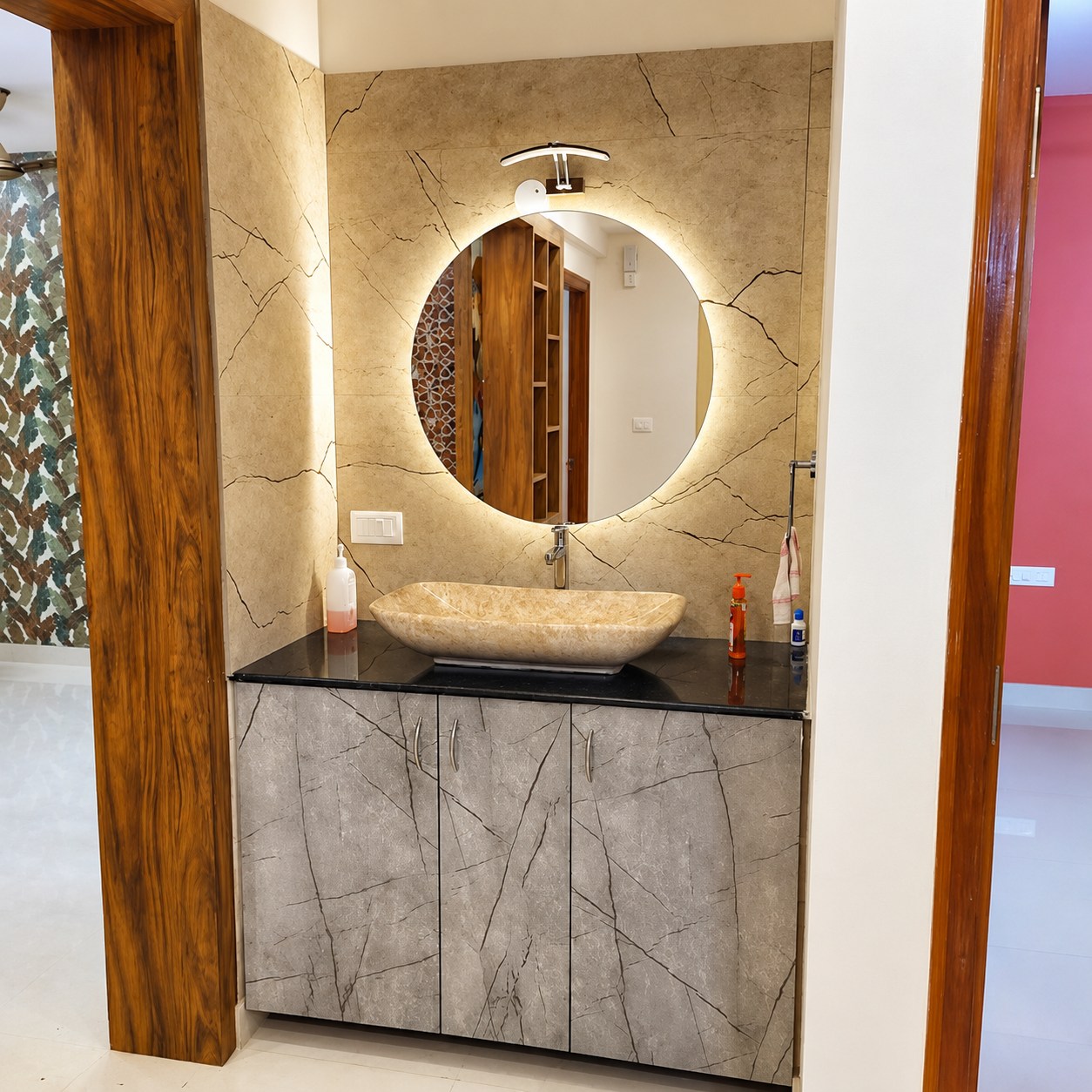 Stone-finish vanity with a softly illuminated round mirror