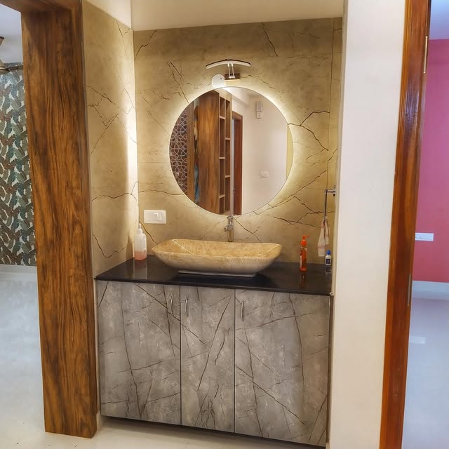 Stone-finish vanity with a softly illuminated round mirror