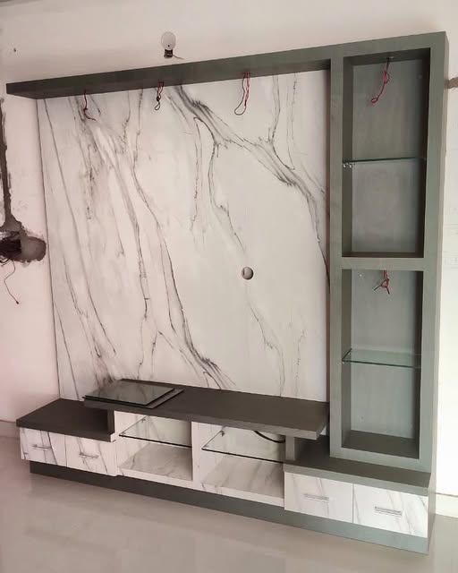 Marble-effect media wall with custom grey cabinetry