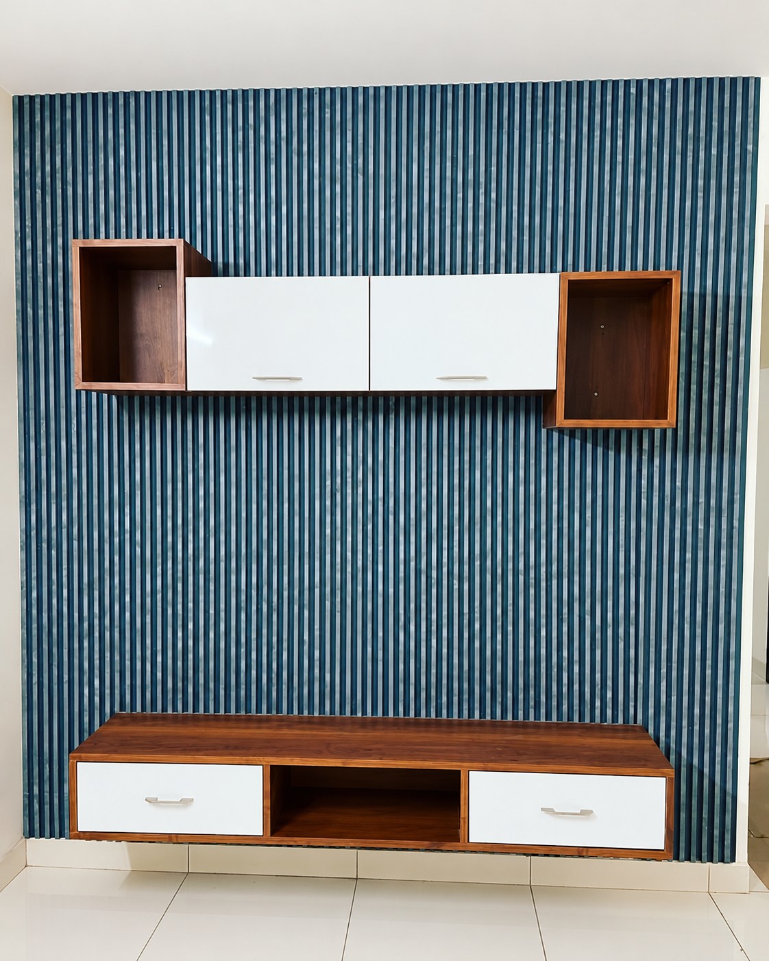 Blue fluted media wall with floating white and wood cabinetry